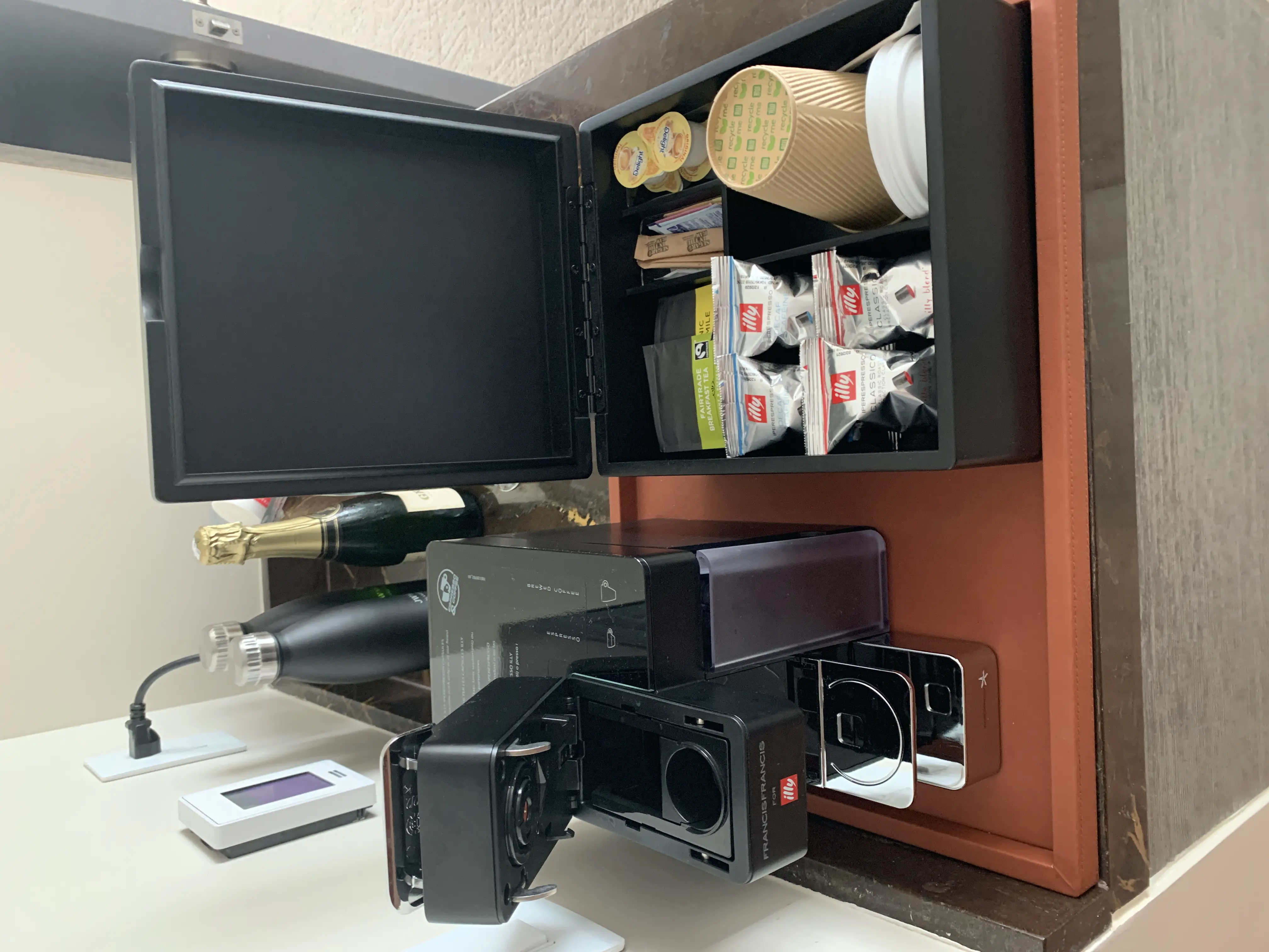 a coffee machine and coffee condiments on a table