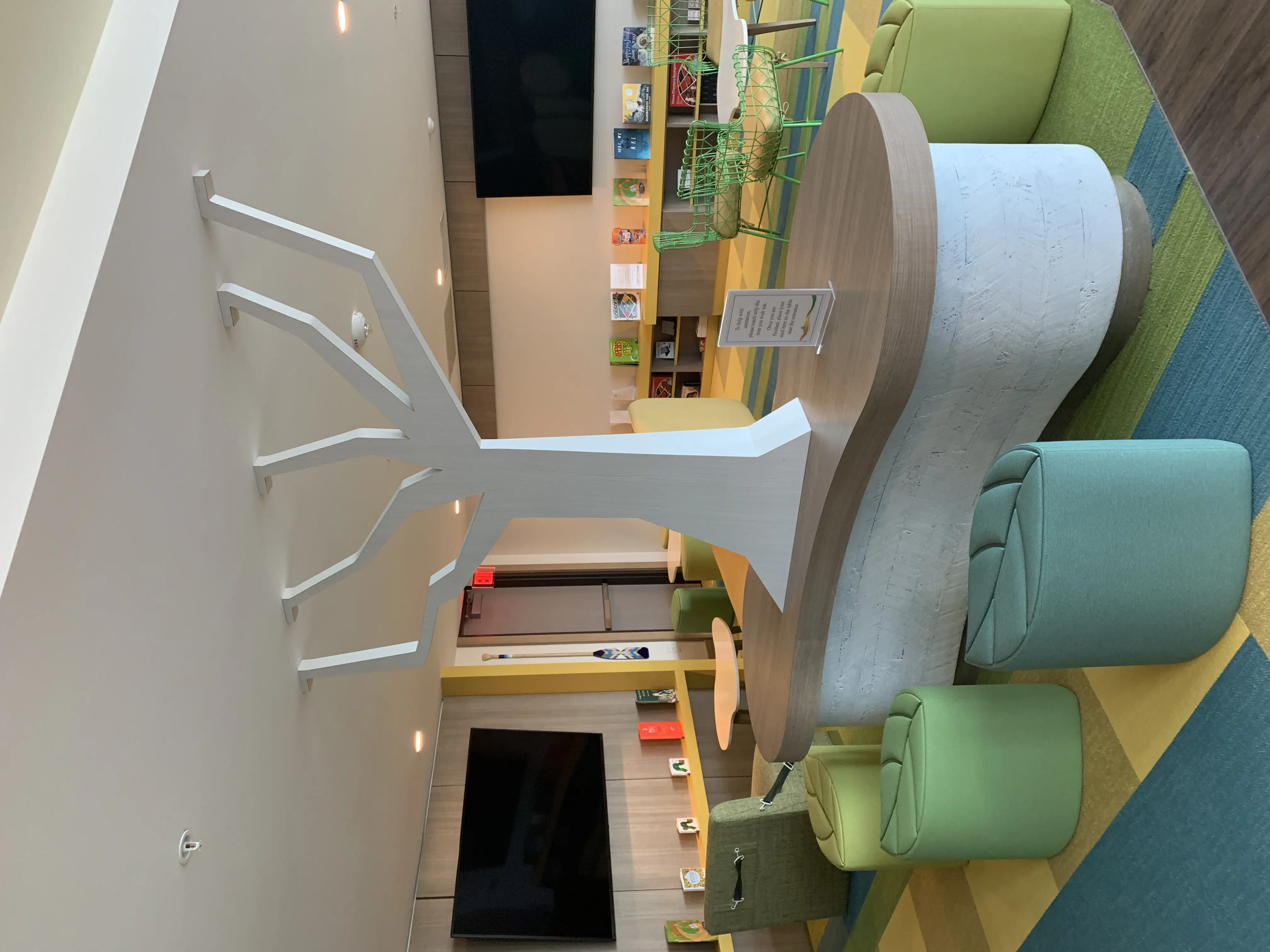 a reception desk with a tree sculpture