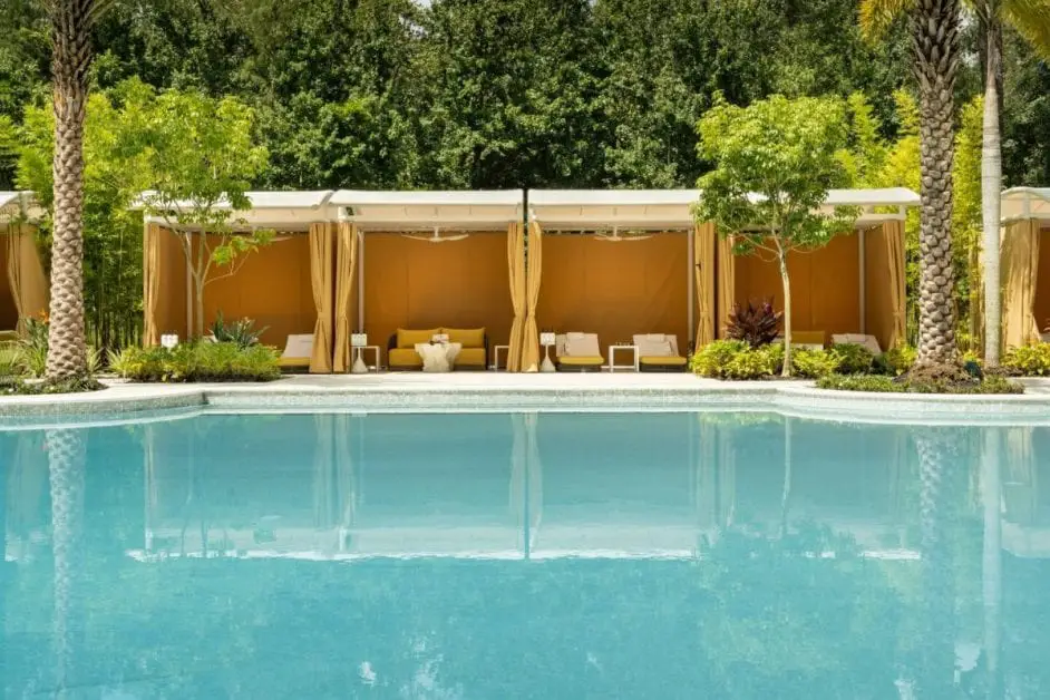 a swimming pool with a gazebo and trees