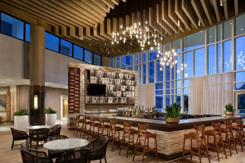 a bar with chairs and a chandelier