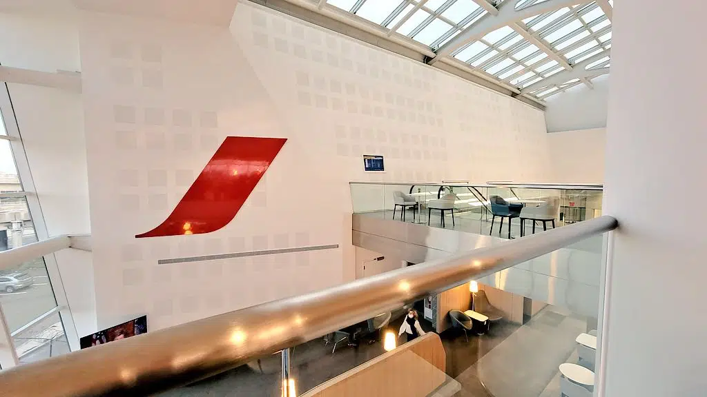 a large white wall with a red logo on it