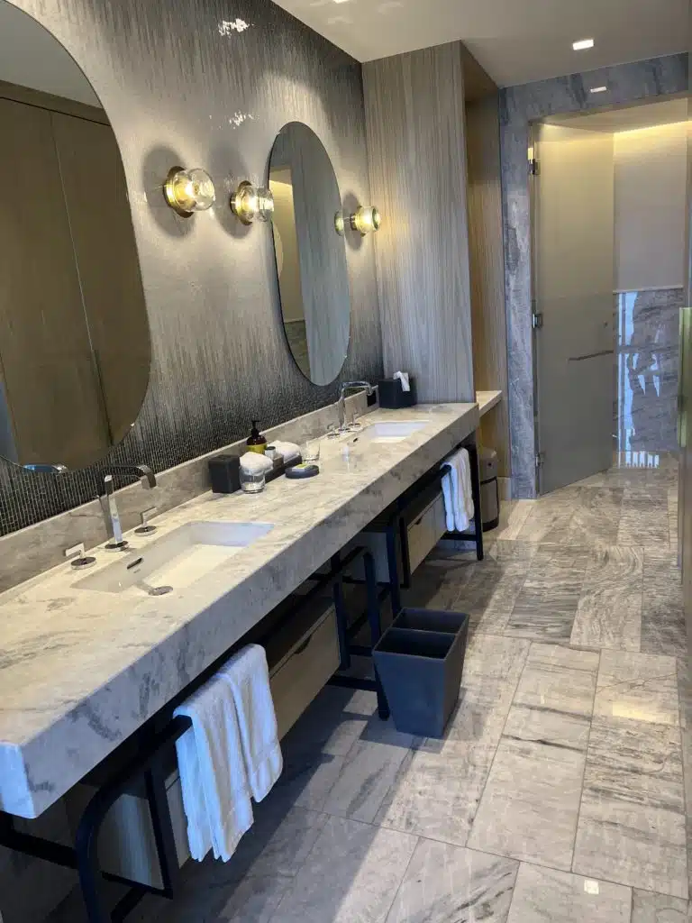 a bathroom with marble countertop sinks and mirrors