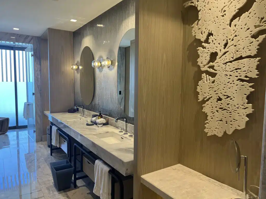 a bathroom with marble counter tops and mirrors